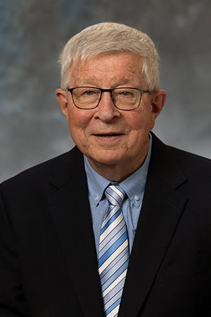 Bob Bruckbauer in a black suit and blue shirt/tie