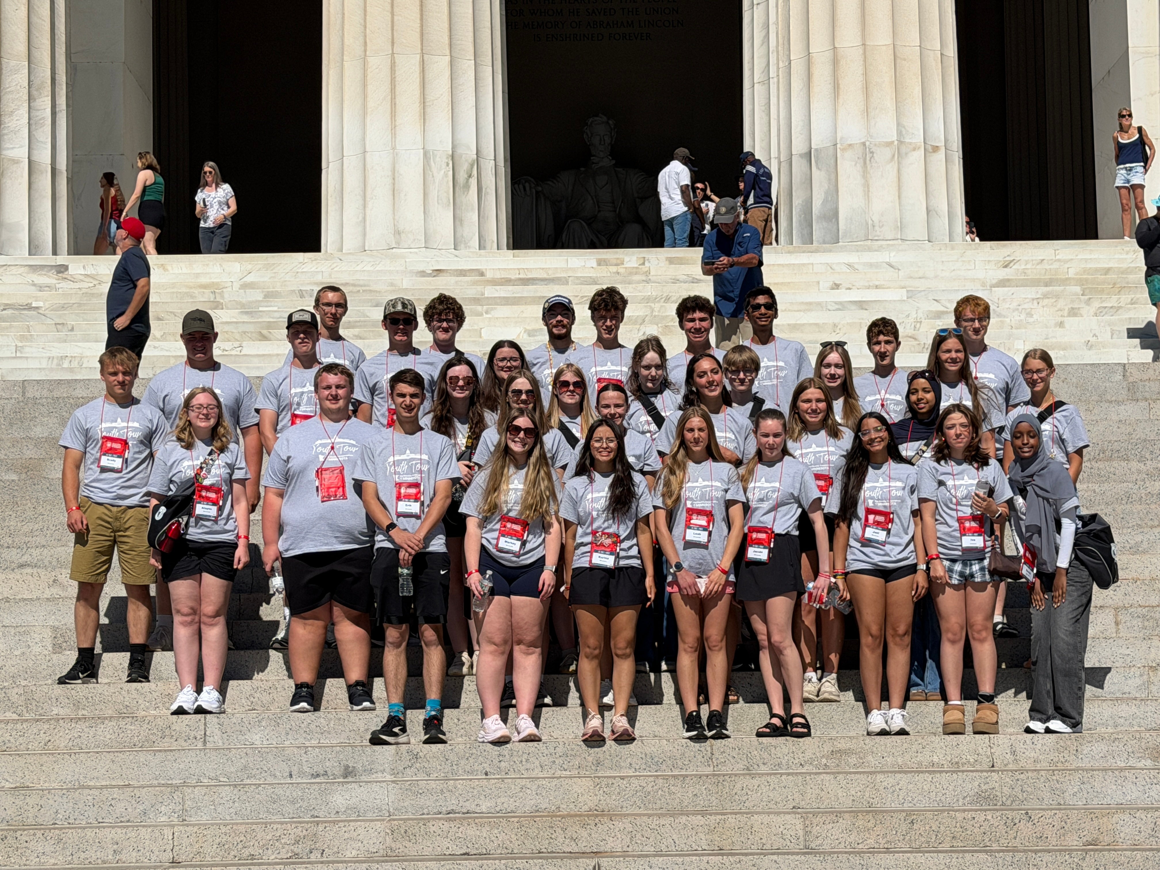 Stduents in gray shirts on the Lincoln Memorial steps
