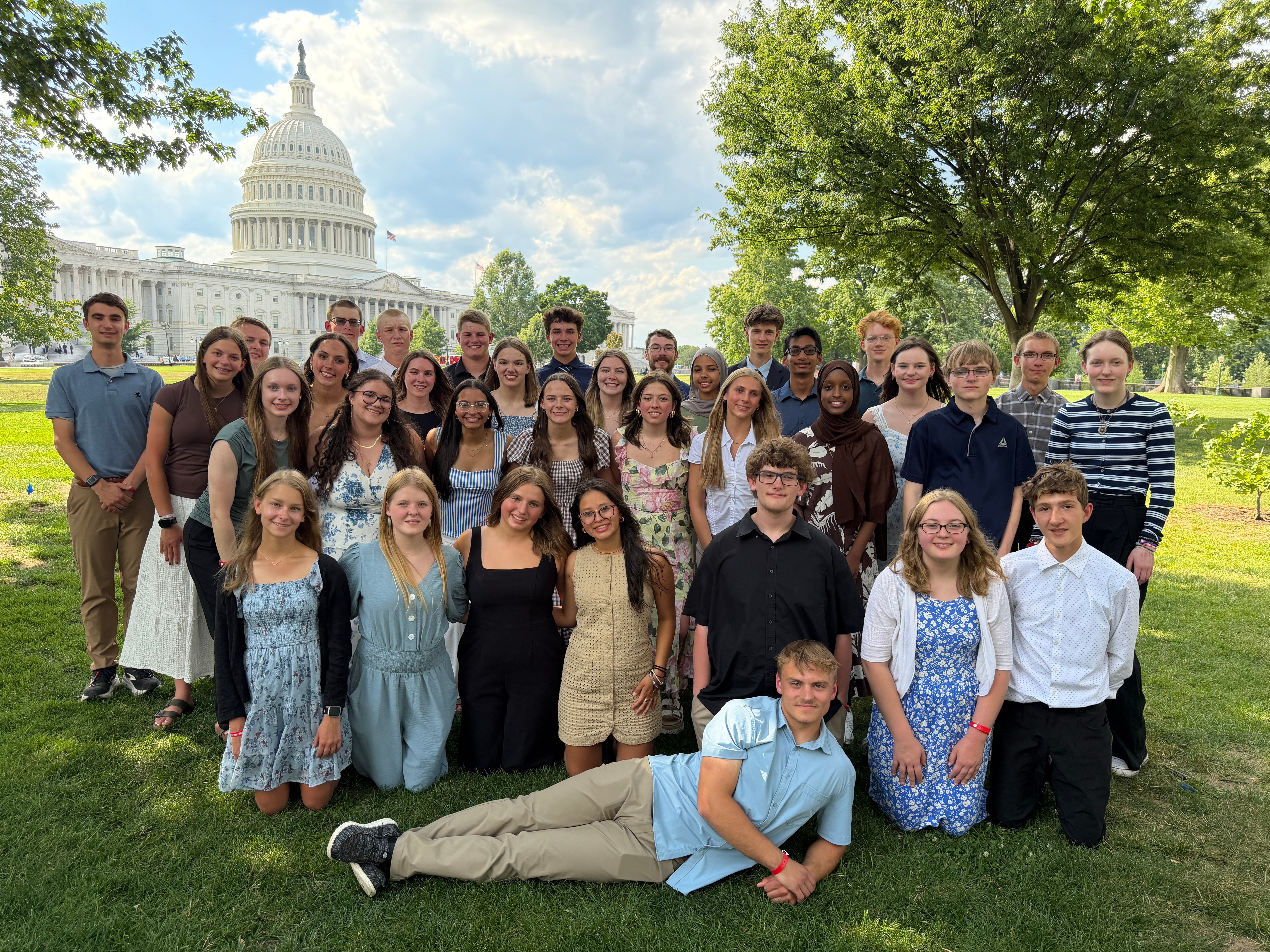 students on green grass outside the US Capitol