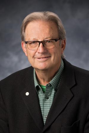 Steve Rauker in green shirt and black jacket