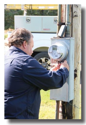 Technician removes an electrical meter